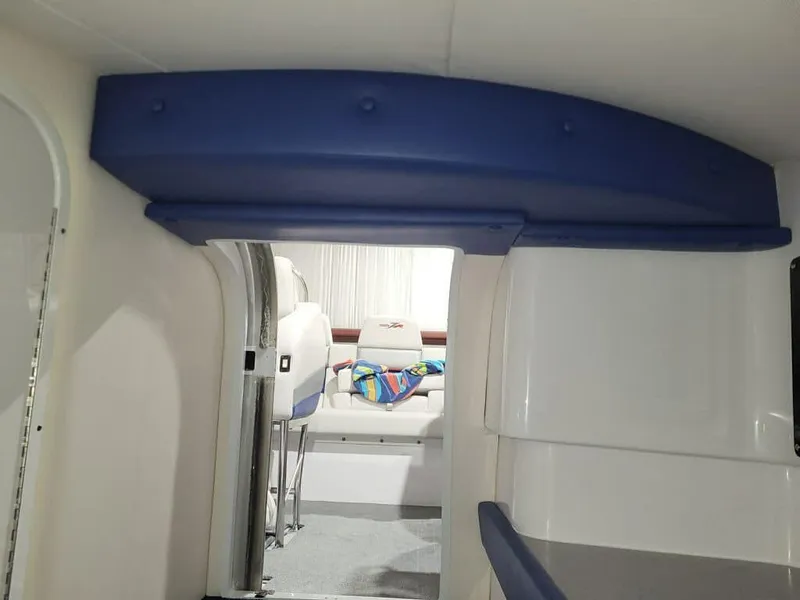 Slide: The Image of Interior of a 2008 Donzi 38 ZR boat, featuring seating and a colorful towel. - 13