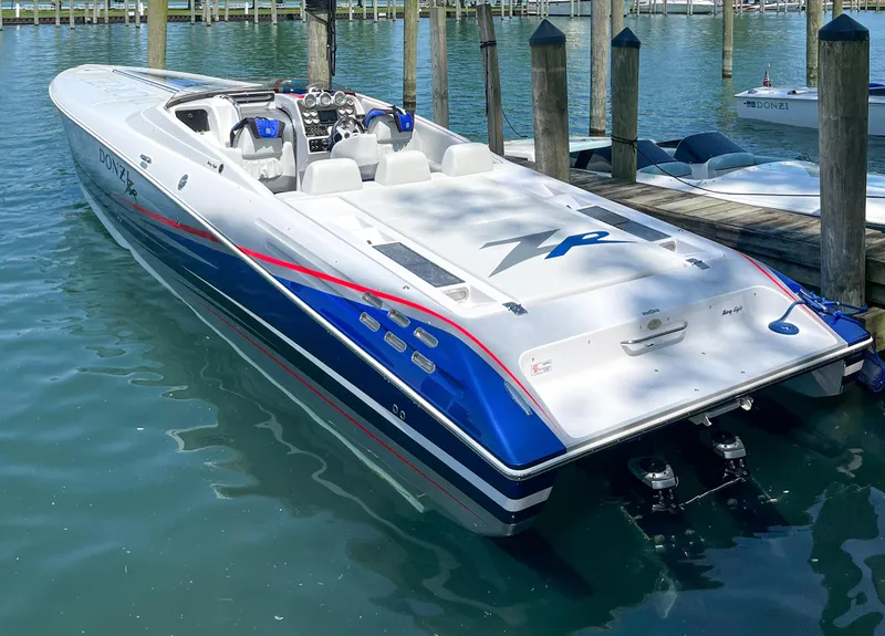 Slide: The Image of 2008 Donzi 38 ZR speedboat docked in clear blue water. - 2