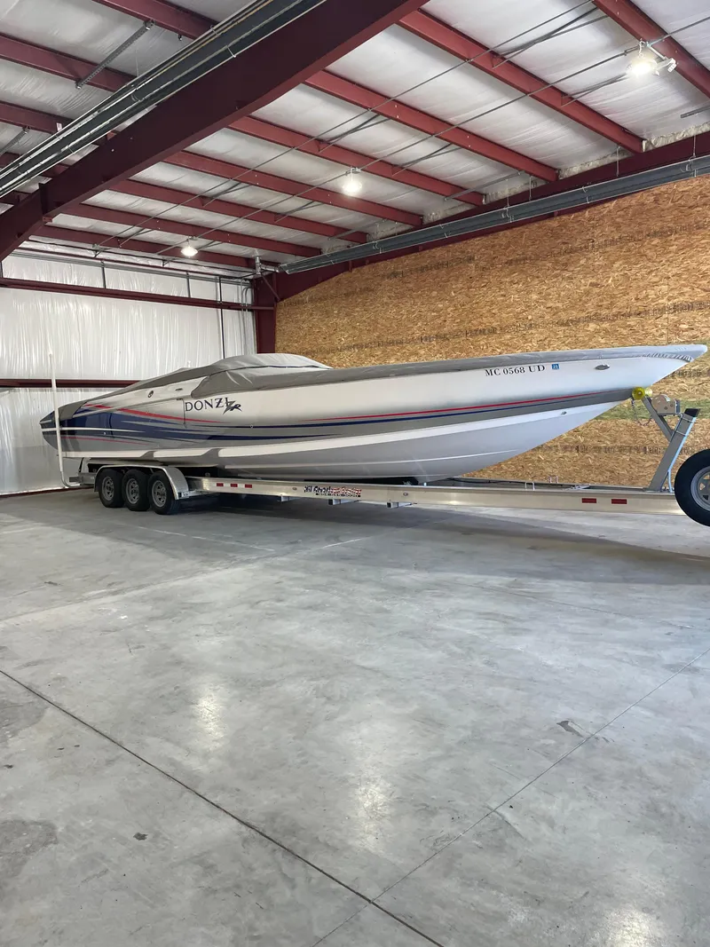 Slide: The Image of 2008 Donzi 38 ZR boat on trailer in a spacious indoor storage facility. - 4