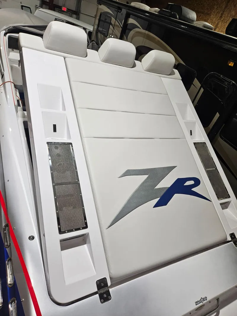 Slide: The Image of 2008 Donzi 38 ZR boat interior with white seating and ZR logo. - 6