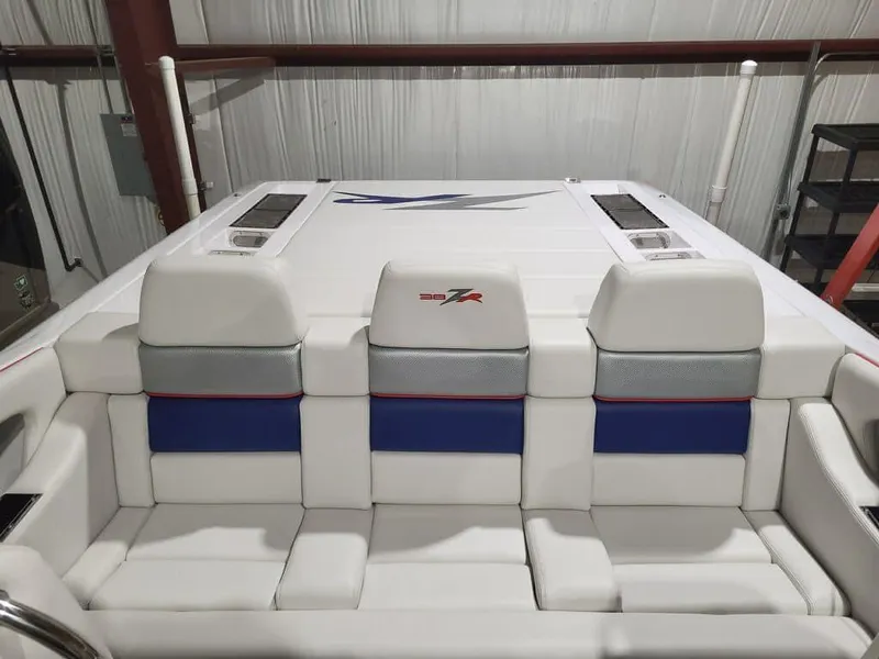 Slide: The Image of 2008 Donzi 38 ZR boat interior with white and blue seating in a garage. - 7