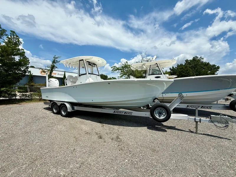 The Image of 2023 Regulator 26XO boat on trailer under blue sky. - 0