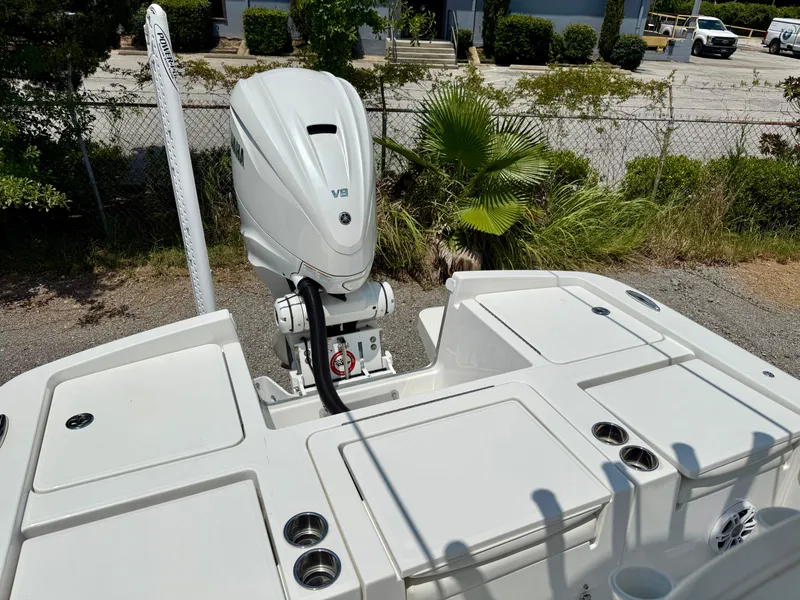 Slide: The Image of 2023 Regulator 26XO boat with Yamaha V8 engine, docked outdoors. - 5