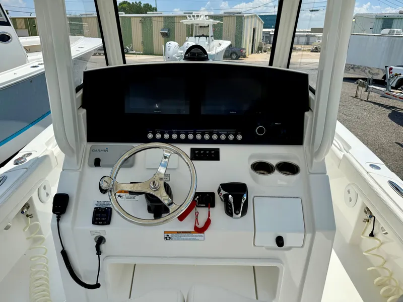 Slide: The Image of 2023 Regulator 26XO boat dashboard with steering wheel and controls. - 6