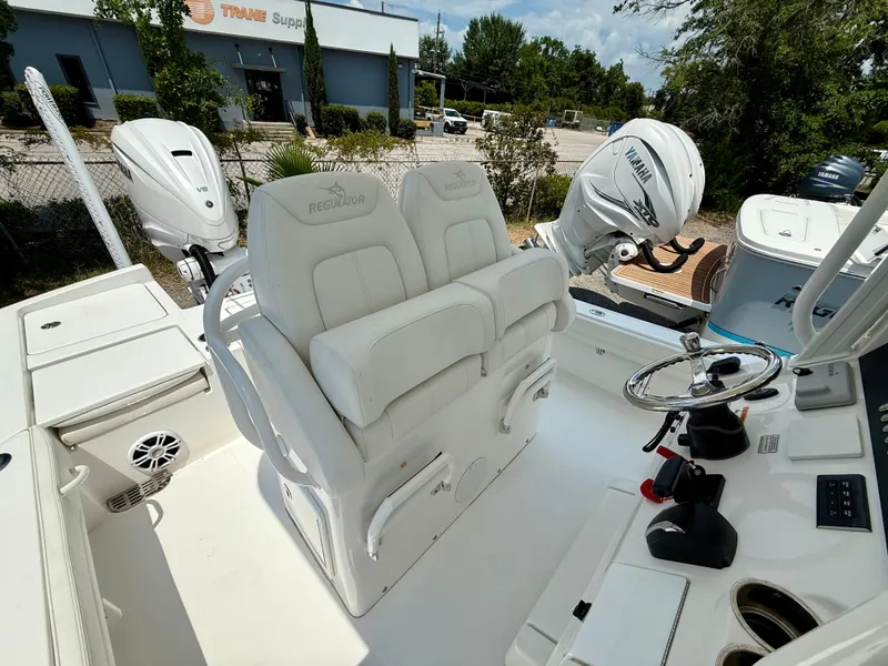 Slide: The Image of 2023 Regulator 26XO boat interior with dual Yamaha engines and steering console. - 7