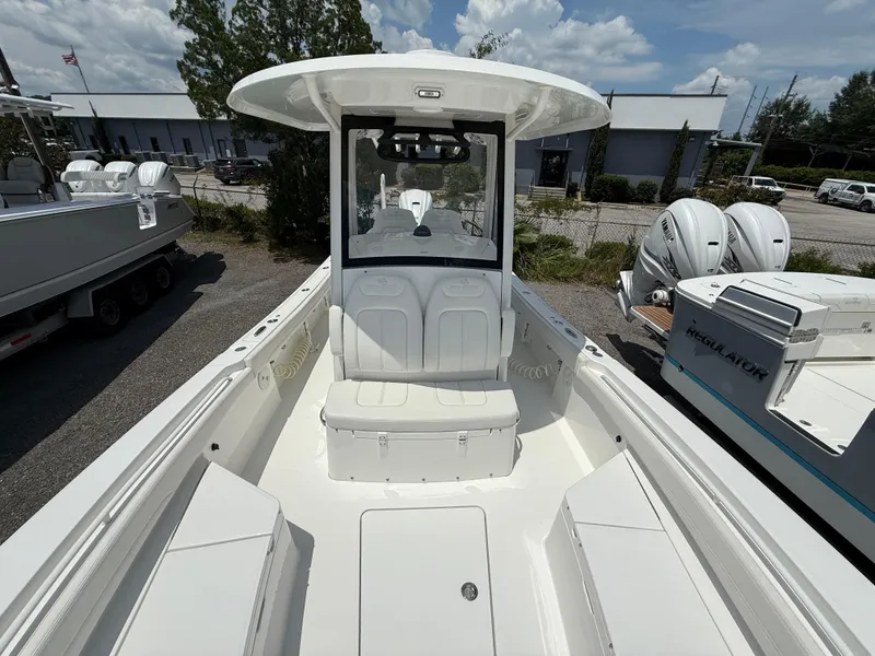 Slide: The Image of 2023 Regulator 26XO boat with seating and console, displayed outdoors under a clear sky. - 9