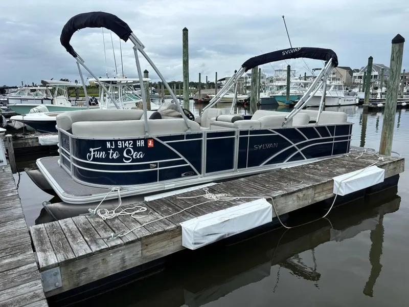 Slide: The Image of 2022 Sylvan Mirage 8522 Resorter pontoon boat docked at marina. - 0