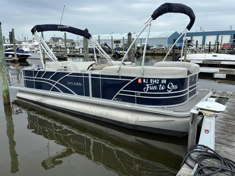 Slide: The Image of 2022 Sylvan Mirage 8522 Resorter pontoon boat docked at marina, labeled "Fun to Sea." - 1