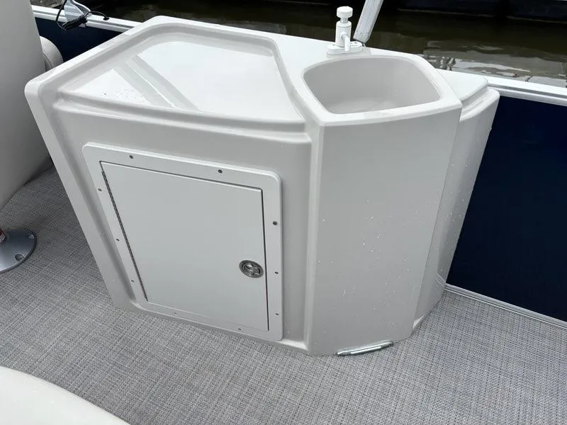 Slide: The Image of 2022 Sylvan Mirage 8522 Resorter boat sink and storage unit on deck. - 10