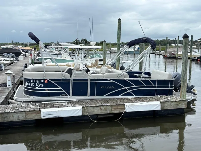 Slide: The Image of 2022 Sylvan Mirage 8522 Resorter pontoon boat docked at marina. - 2