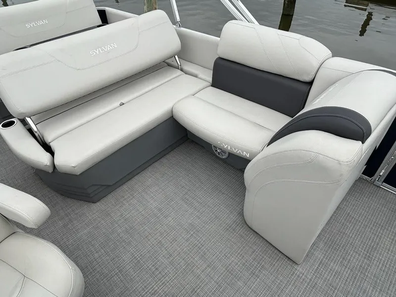 Slide: The Image of 2022 Sylvan Mirage 8522 Resorter boat interior with gray seating and carpeted flooring. - 5
