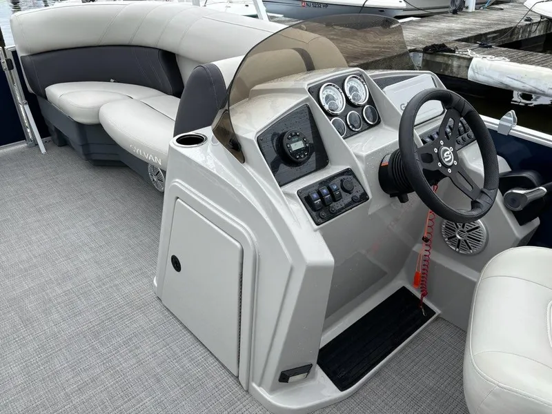 Slide: The Image of 2022 Sylvan Mirage 8522 Resorter boat interior with steering console and seating. - 6