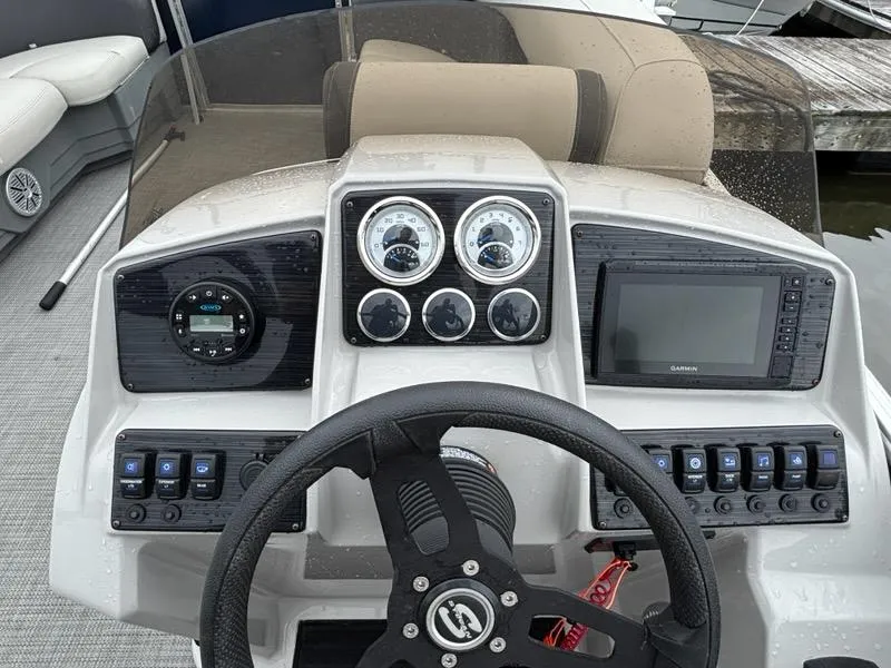 Slide: The Image of 2022 Sylvan Mirage 8522 Resorter dashboard with steering wheel, gauges, and navigation system. - 7