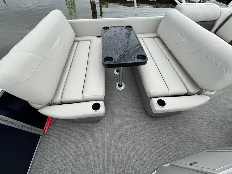 Slide: The Image of 2022 Sylvan Mirage 8522 Resorter boat interior with gray seating and black table. - 9