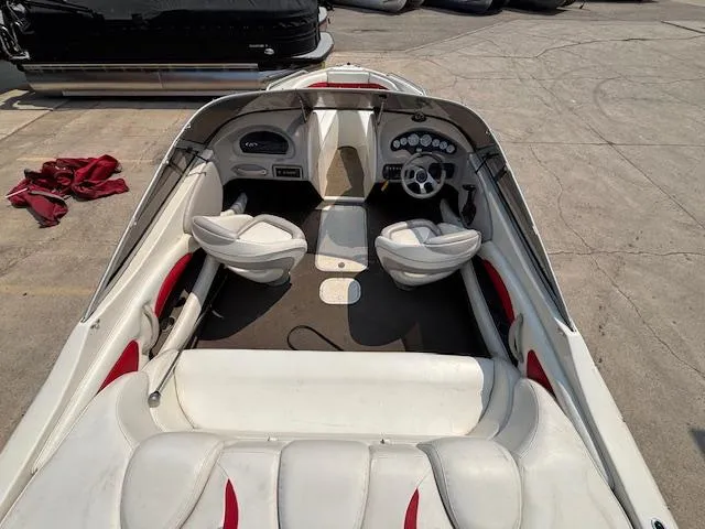 Slide: The Image of 2006 Stingray 220 LX boat interior with white and red seating, dashboard, and steering wheel. - 10