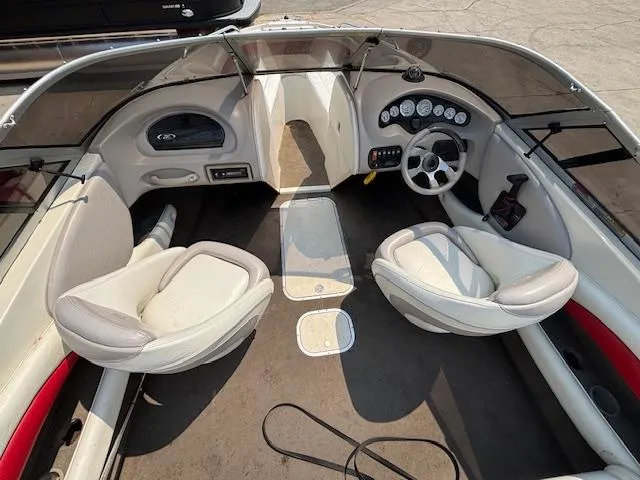Slide: The Image of 2006 Stingray 220 LX boat interior with dual seats and dashboard controls. - 11