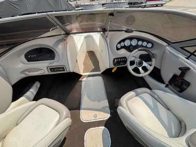 Slide: The Image of 2006 Stingray 220 LX boat interior with steering wheel and dashboard controls. - 12