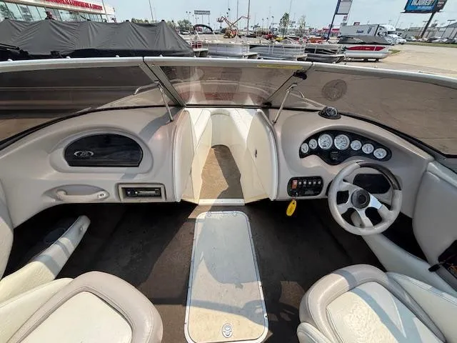 Slide: The Image of 2006 Stingray 220 LX boat interior with steering wheel, dashboard, and seating. - 16