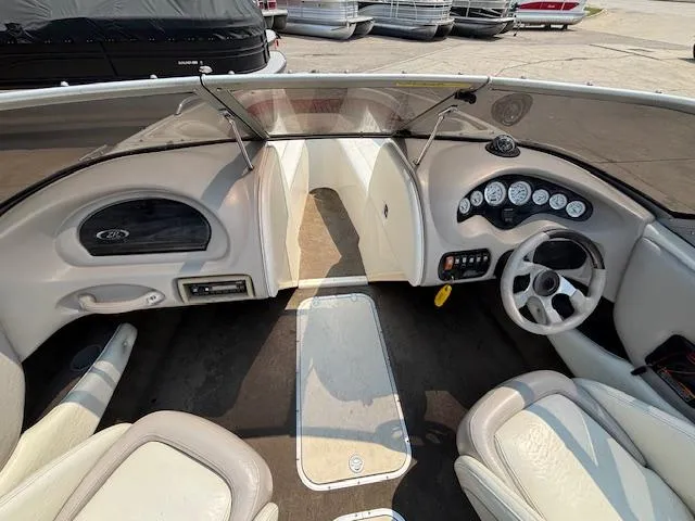 Slide: The Image of 2006 Stingray 220 LX boat interior with steering wheel, dashboard, and seating. - 17