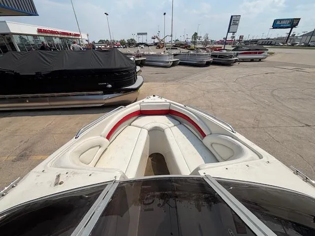 Slide: The Image of 2006 Stingray 220 LX boat with red and white interior, parked in a marina. - 19