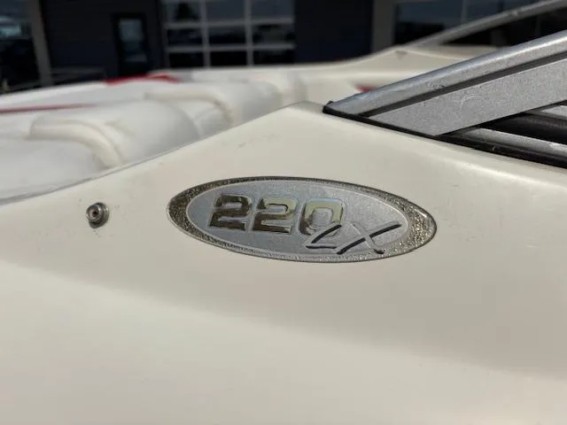 Slide: The Image of 2006 Stingray 220 LX boat emblem on white surface, close-up view. - 6