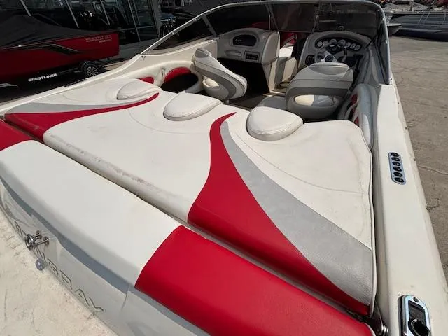 Slide: The Image of 2006 Stingray 220 LX boat interior with red and white seating and dashboard view. - 8