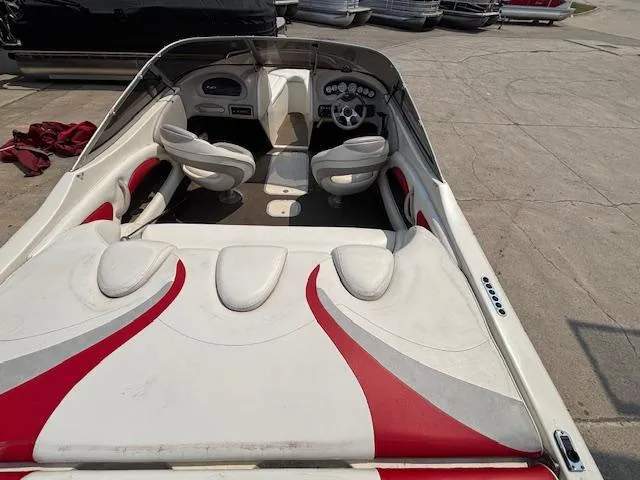 Slide: The Image of 2006 Stingray 220 LX boat interior with red and white seating, dashboard, and steering wheel. - 9