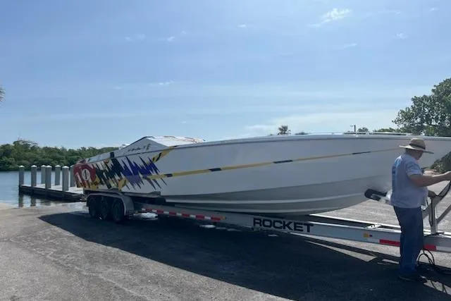 The Image of 2000 Cigarette Top Gun T/S 38 speedboat on trailer at boat launch. - 1