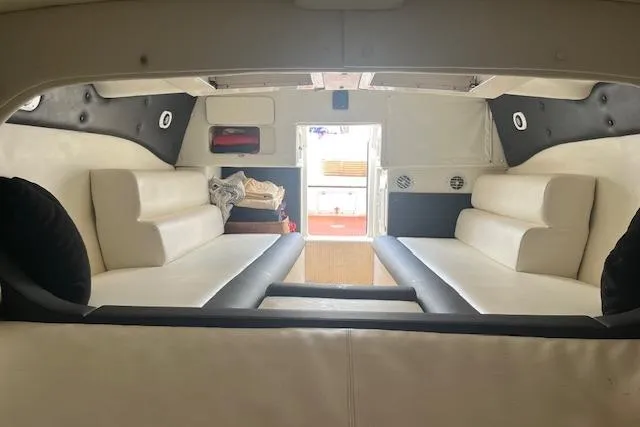 Slide: The Image of Interior of 2000 Cigarette Top Gun T/S 38 boat with white seating and modern design. - 13