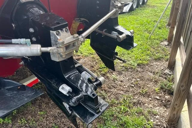 Slide: The Image of 2000 Cigarette Top Gun T/S 38 boat engine components on grassy ground. - 15