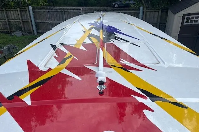 Slide: The Image of 2000 Cigarette Top Gun T/S 38 boat with vibrant abstract graphics on deck. - 3