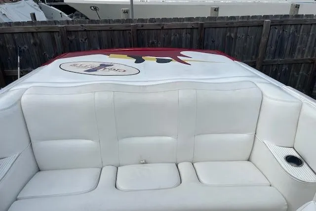 Slide: The Image of 2000 Cigarette Top Gun T/S 38 boat with white seating and colorful logo. - 6