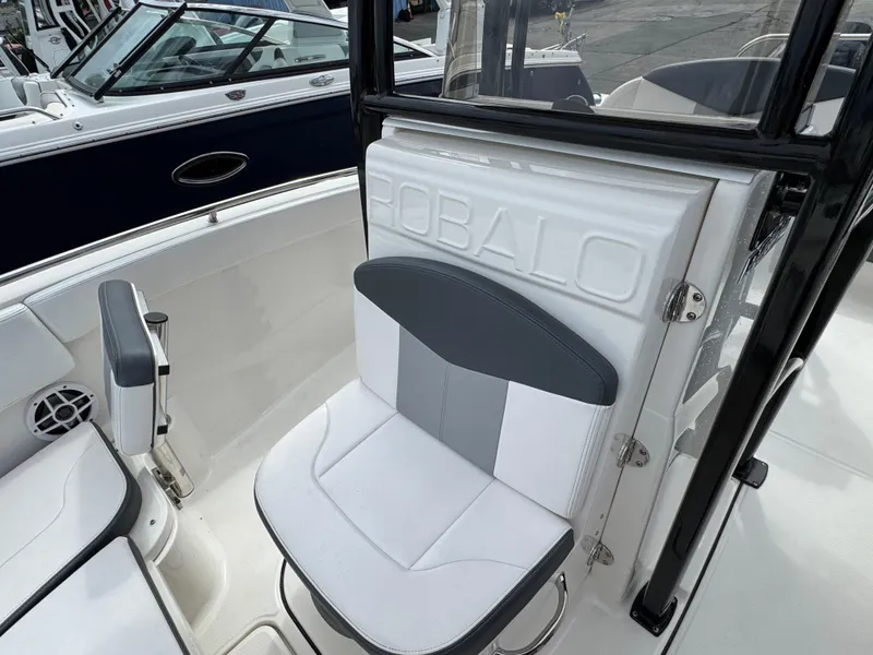 Slide: The Image of 2021 Robalo R222 Explorer boat interior with white and gray seating. - 12
