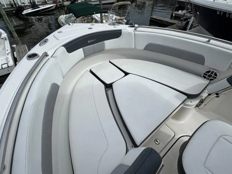Slide: The Image of 2021 Robalo R222 Explorer boat interior with cushioned seating and sleek design. - 13