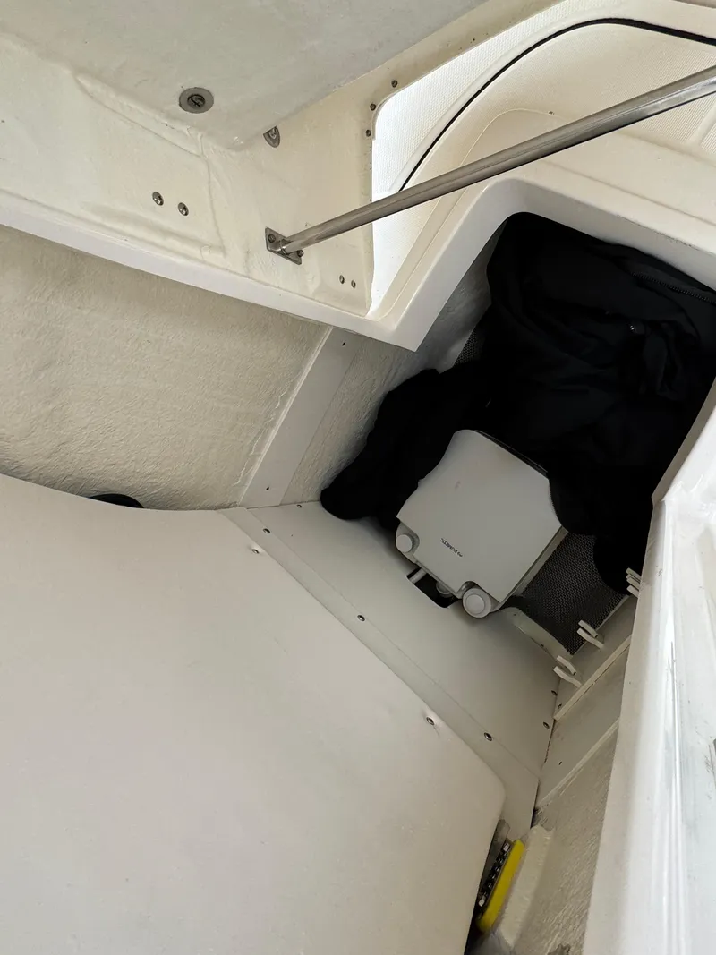 Slide: The Image of 2021 Robalo R222 Explorer cabin interior with storage and equipment. - 14