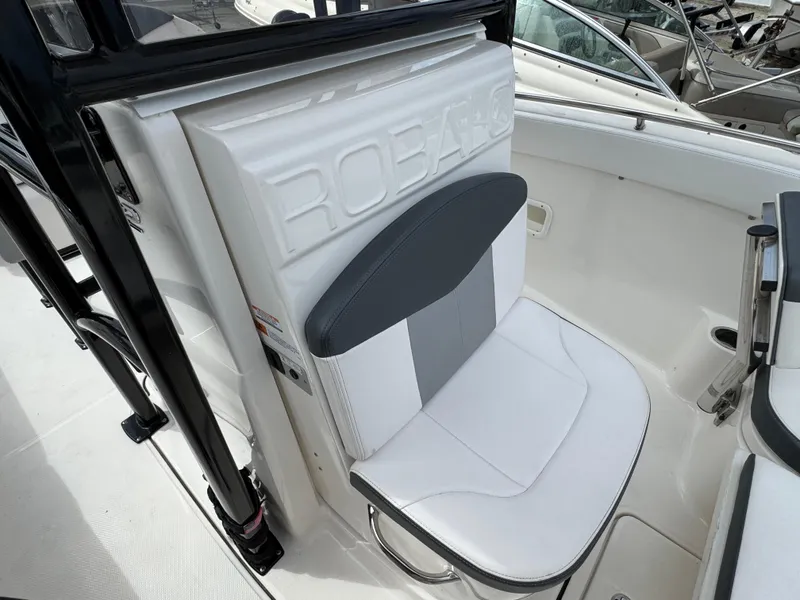 Slide: The Image of 2021 Robalo R222 Explorer boat seat with white and gray upholstery. - 15