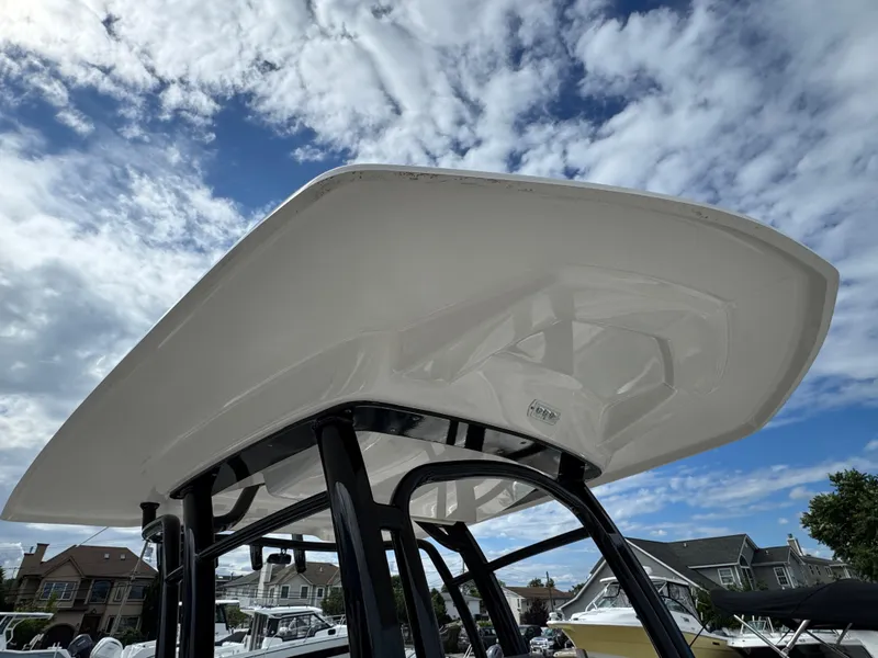 Slide: The Image of 2021 Robalo R222 Explorer boat with T-top against a cloudy sky. - 16