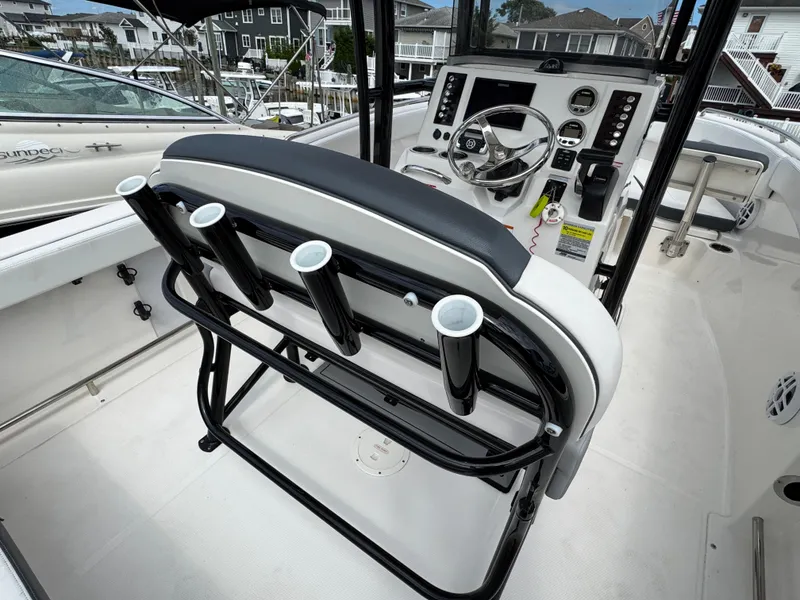 Slide: The Image of 2021 Robalo R222 Explorer boat interior with steering console and rod holders. - 5