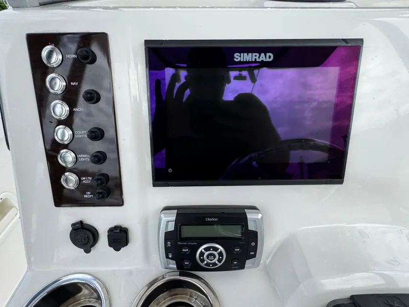 Slide: The Image of Control panel of 2021 Robalo R222 Explorer with Simrad display and Clarion audio system. - 6