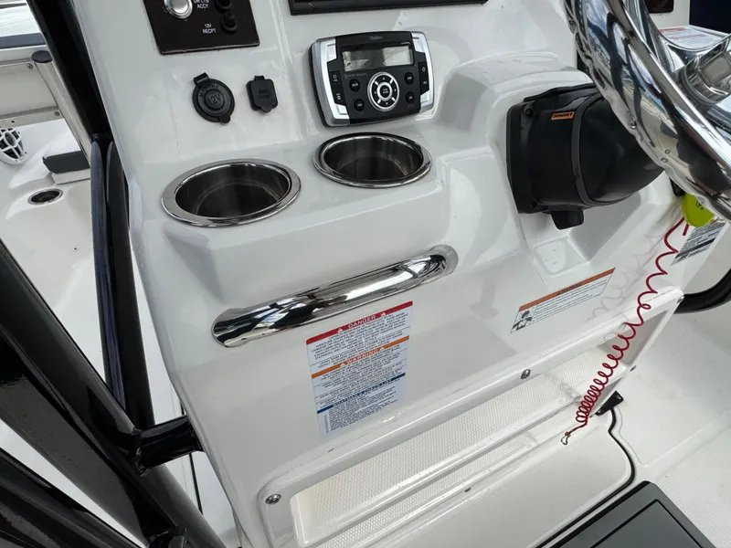 Slide: The Image of 2021 Robalo R222 Explorer dashboard with cup holders and control panel. - 8