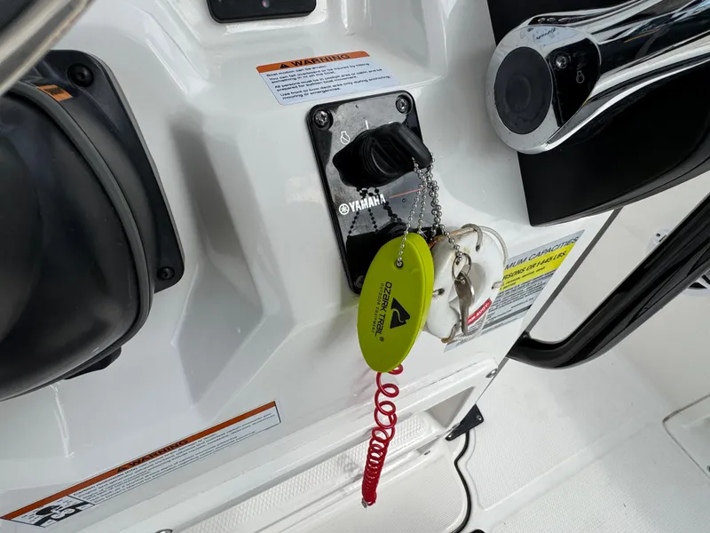 Slide: The Image of Close-up of 2021 Robalo R222 Explorer boat ignition with keys and safety lanyard. - 9