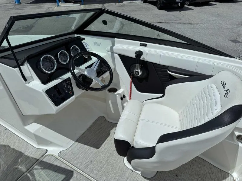 Slide: The Image of Interior of a 2022 Sea Ray SPX 190 boat, featuring steering wheel and dashboard controls. - 10