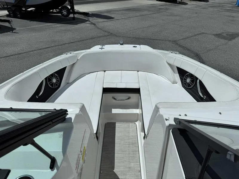 Slide: The Image of 2022 Sea Ray SPX 190 boat interior with white seating and speakers. - 11