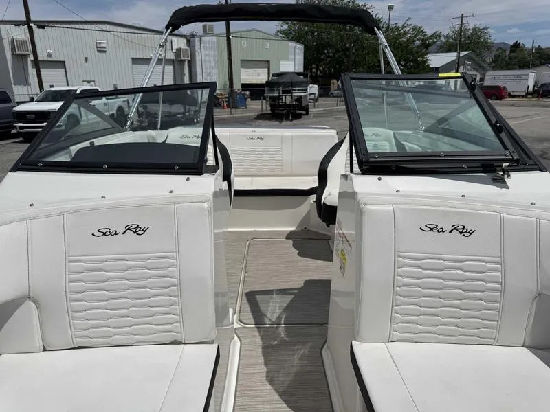 Slide: The Image of 2022 Sea Ray SPX 190 boat interior with white seating and open windshield. - 12