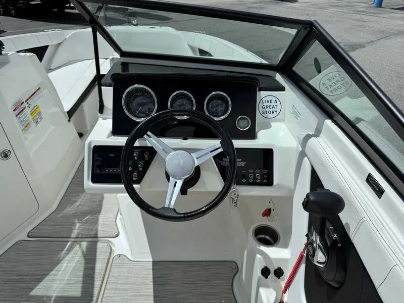 Slide: The Image of 2022 Sea Ray SPX 190 boat dashboard with steering wheel and control panel. - 14