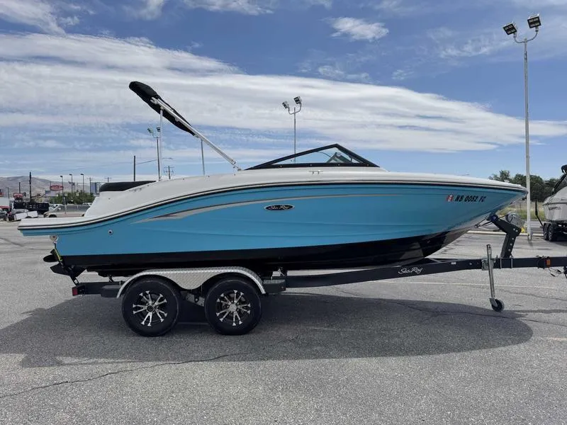 Slide: The Image of 2022 Sea Ray SPX 190 boat on trailer, blue and white design, parked outdoors. - 3