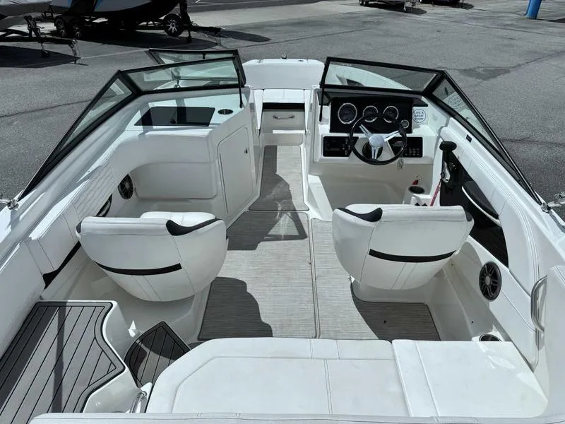 Slide: The Image of 2022 Sea Ray SPX 190 boat interior with white seating and modern dashboard. - 9