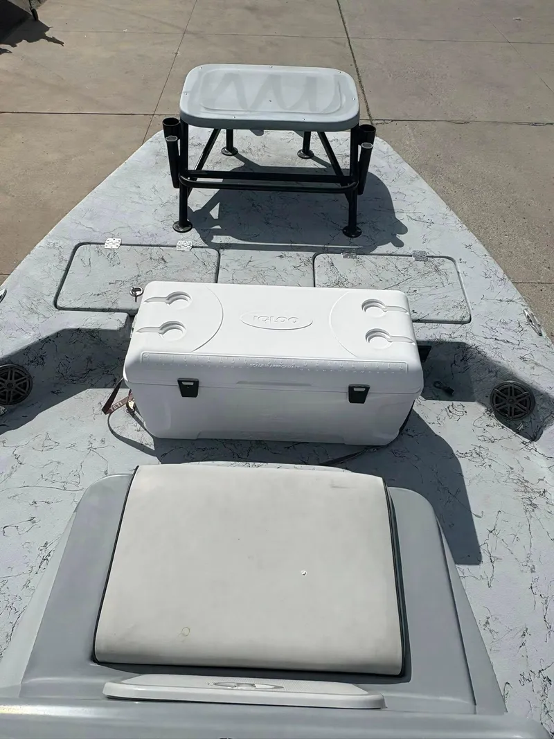 Slide: The Image of 2014 Shoalwater 21 Catamaran deck with cooler and seating. - 11