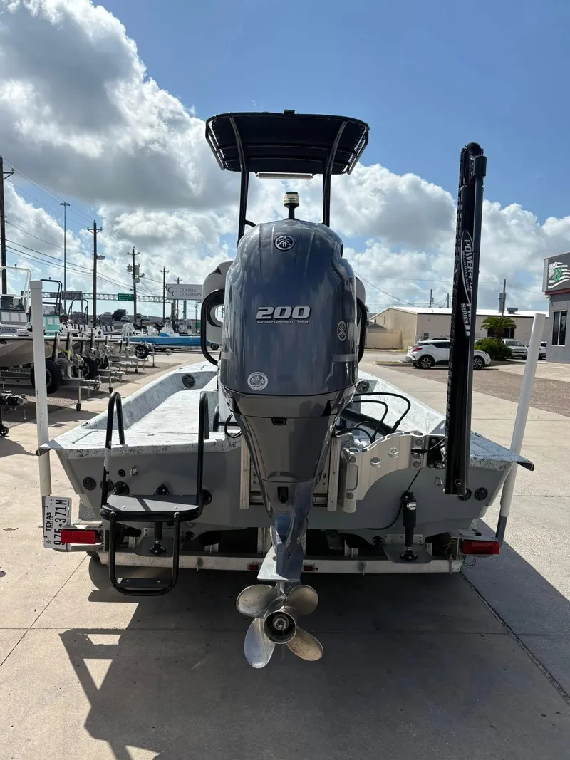 Slide: The Image of 2014 Shoalwater 21 Catamaran with Yamaha 200 outboard motor, parked outdoors. - 2