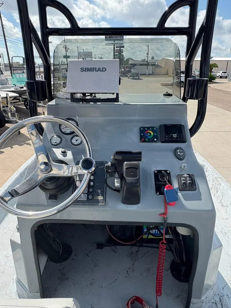 Slide: The Image of Control panel of a 2014 Shoalwater 21 Catamaran with Simrad navigation system. - 3